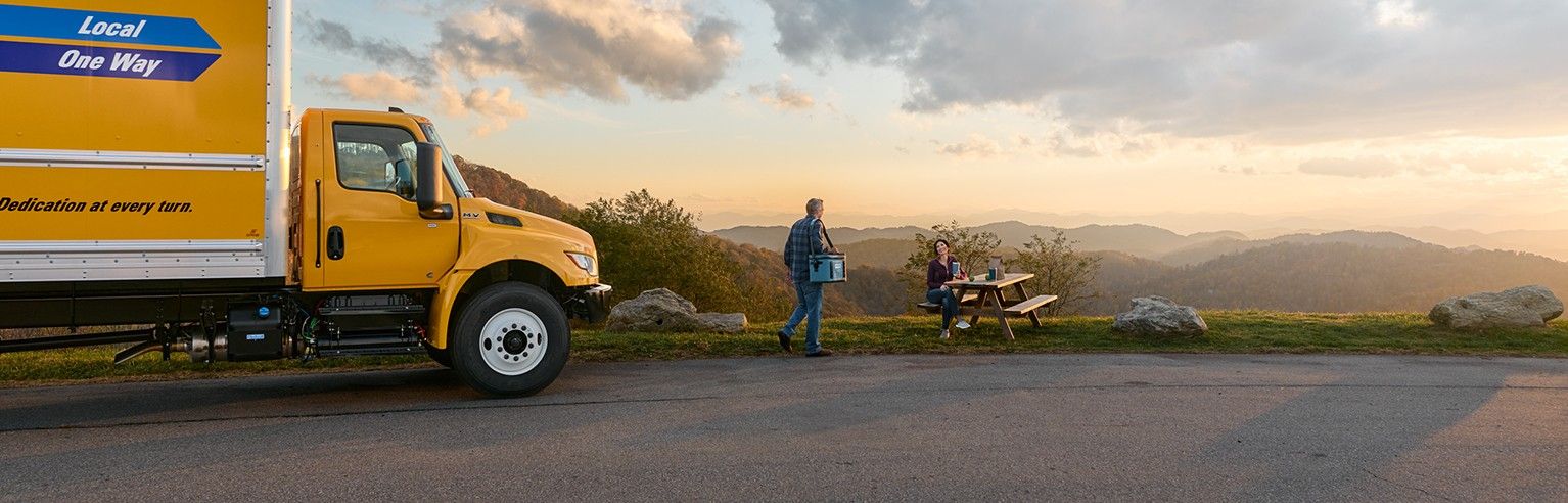 Family at picnic with their moving truck rental