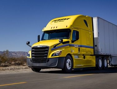 Penske tractor trailer driving on a desert road