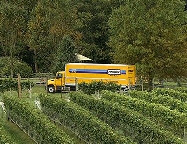 Penske truck driving in a farm